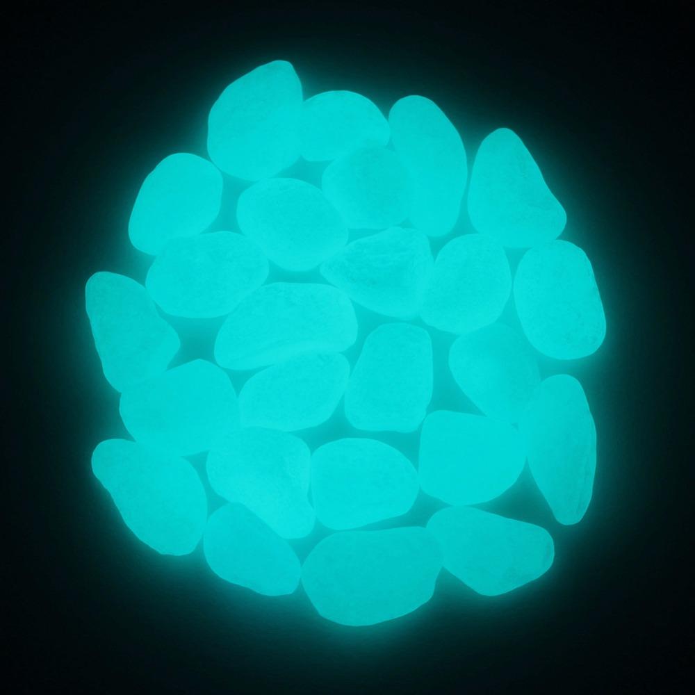 Close-up of a tight cluster of glowing aqua pebbles showing their brightness