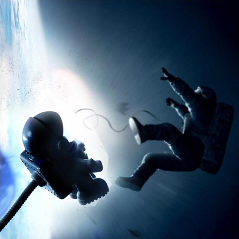 Flexible lamp cable running along a desk beside the astronaut