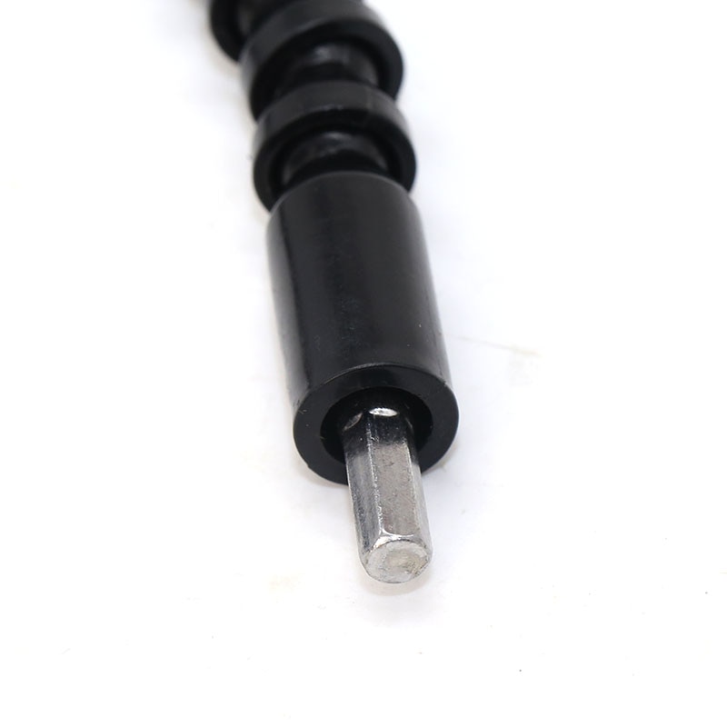 Segmented black shaft bent around a corner with the bit seated at the end