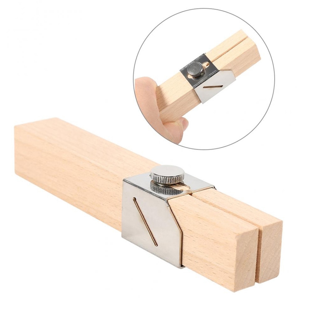 Hand gripping the wooden bottle cutter with the blade assembly in view