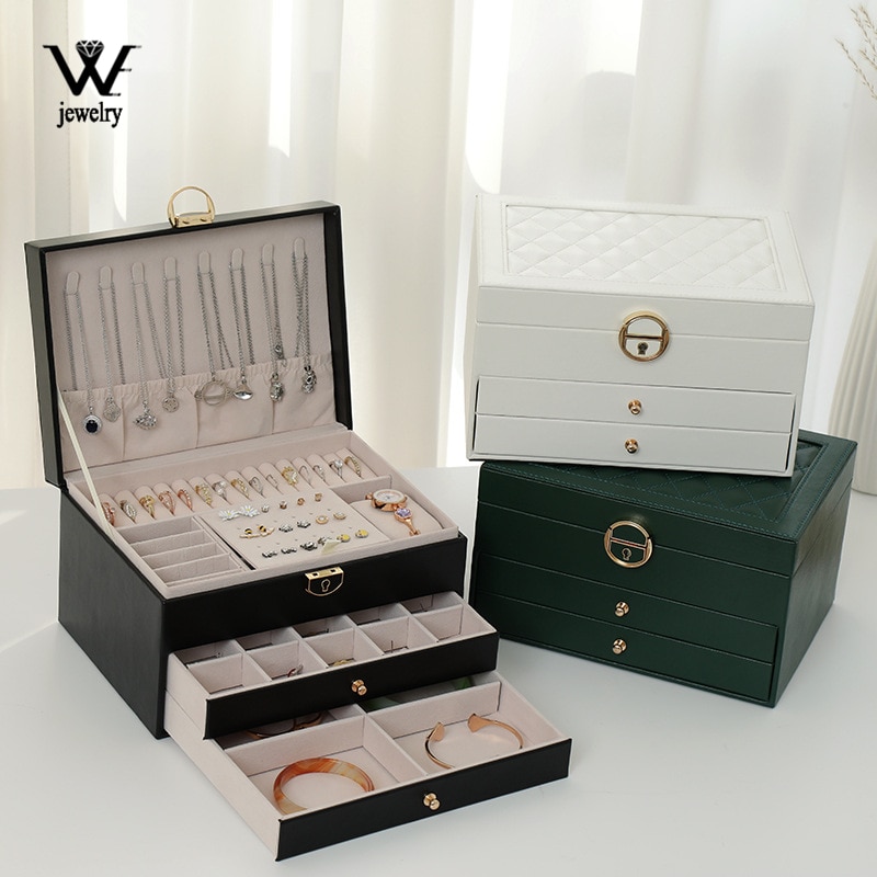 Green, black and white jewelry boxes shown with necklaces, earrings and bangles inside