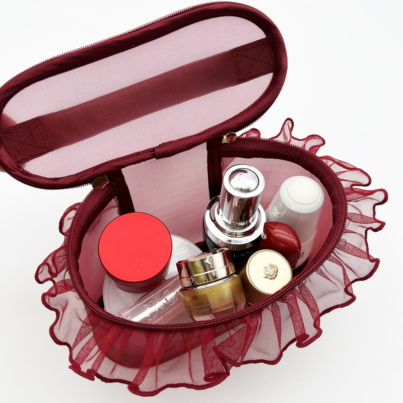 Open burgundy mesh case showing interior lining and products stored inside