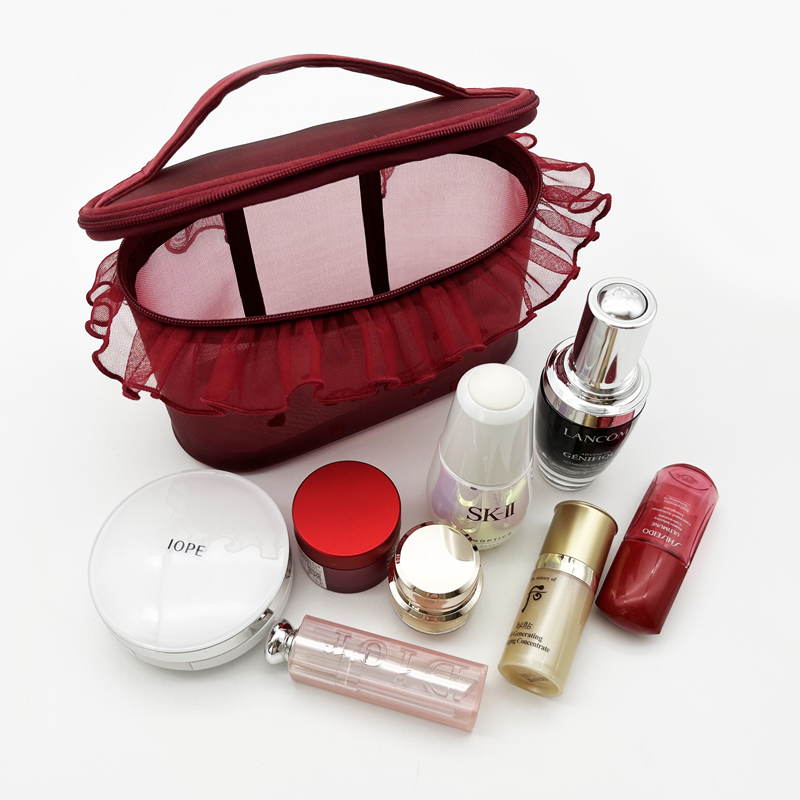 Burgundy mesh top-handle case with ruffled lace trim filled with bottles