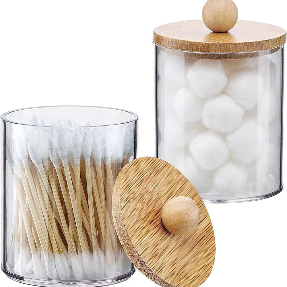 Clear jars with bamboo lids showing swabs and cotton balls inside