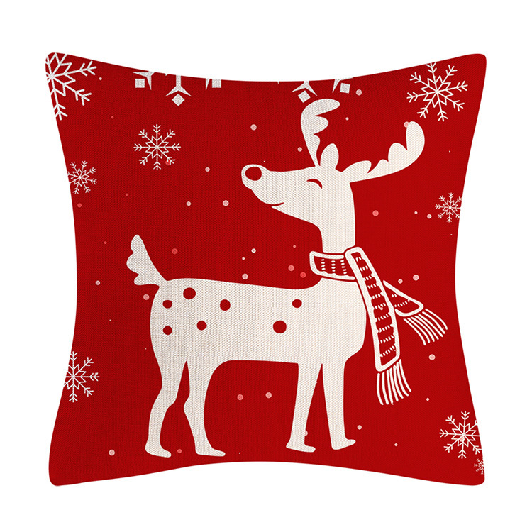 Red holiday cushion covers arranged together on a sofa
