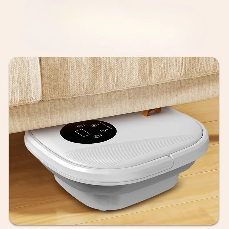 Foot bath tub tucked under a beige sofa on a wooden floor