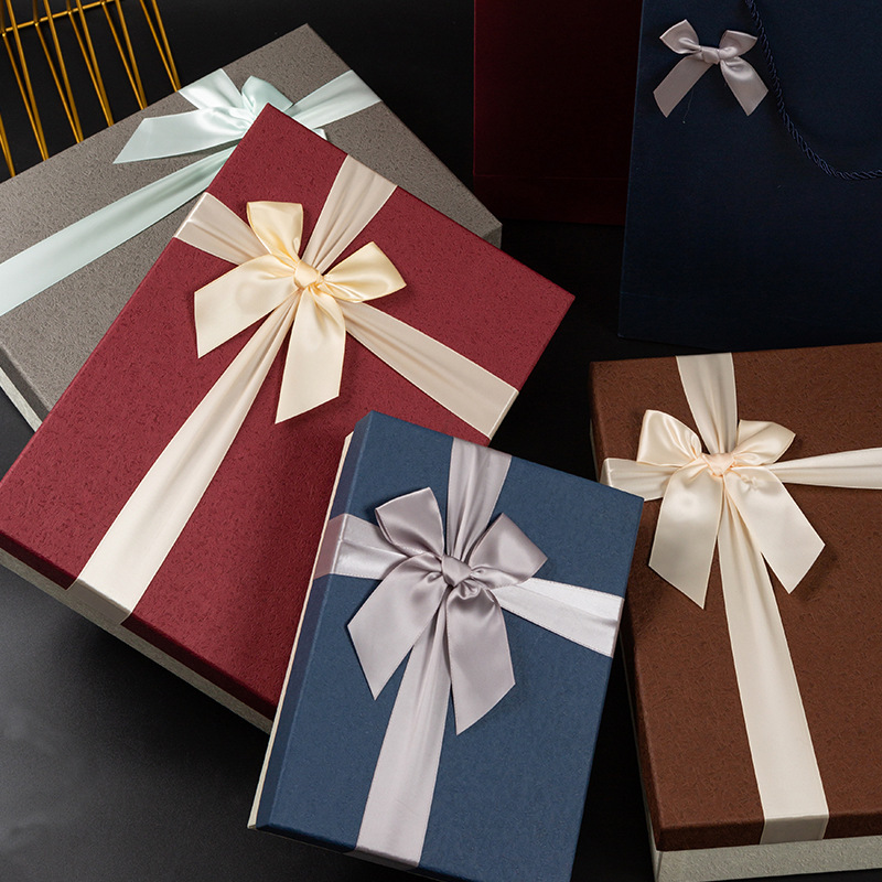Gift boxes in grey, burgundy, navy and brown with satin bows