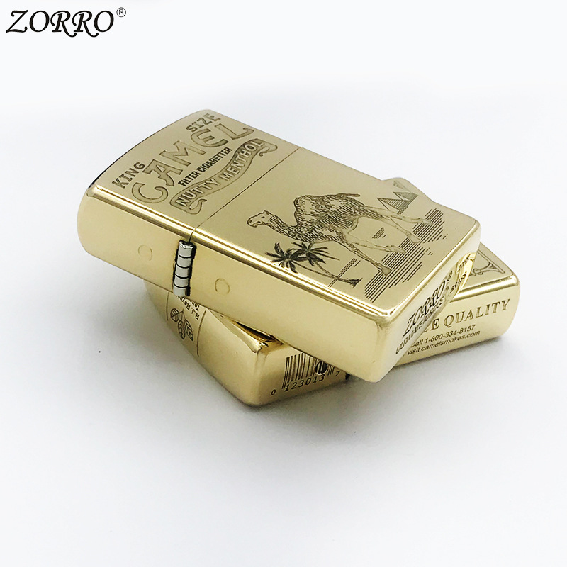 Brass lighter lying on its side showing hinge and body thickness