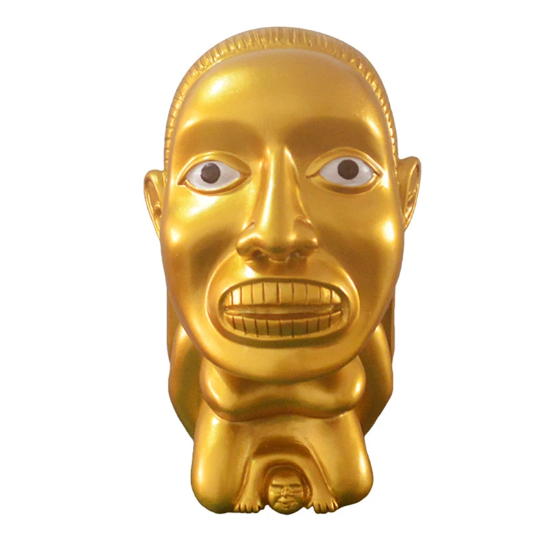 Front view of gold idol statue showing sculpted face and painted-style eyes