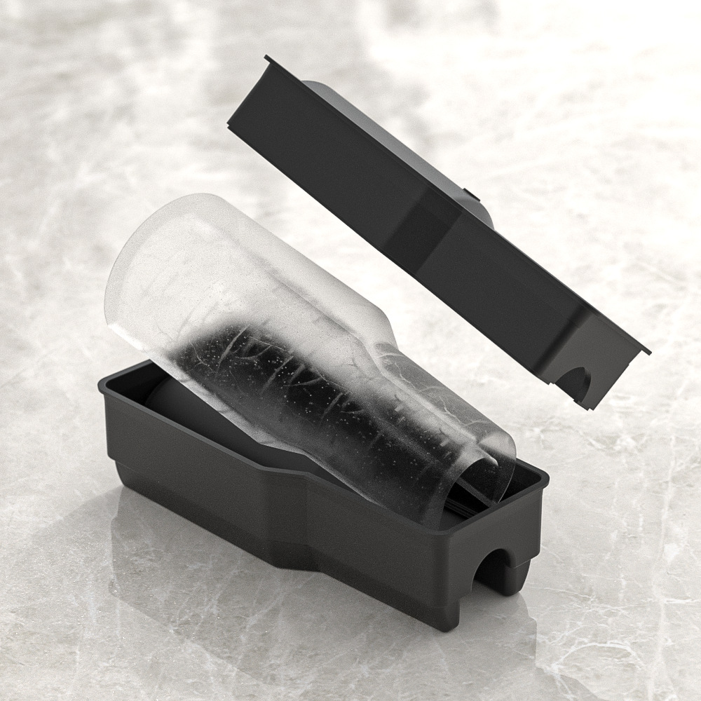 Charcoal mold beside a clear ice piece with the lid lifted