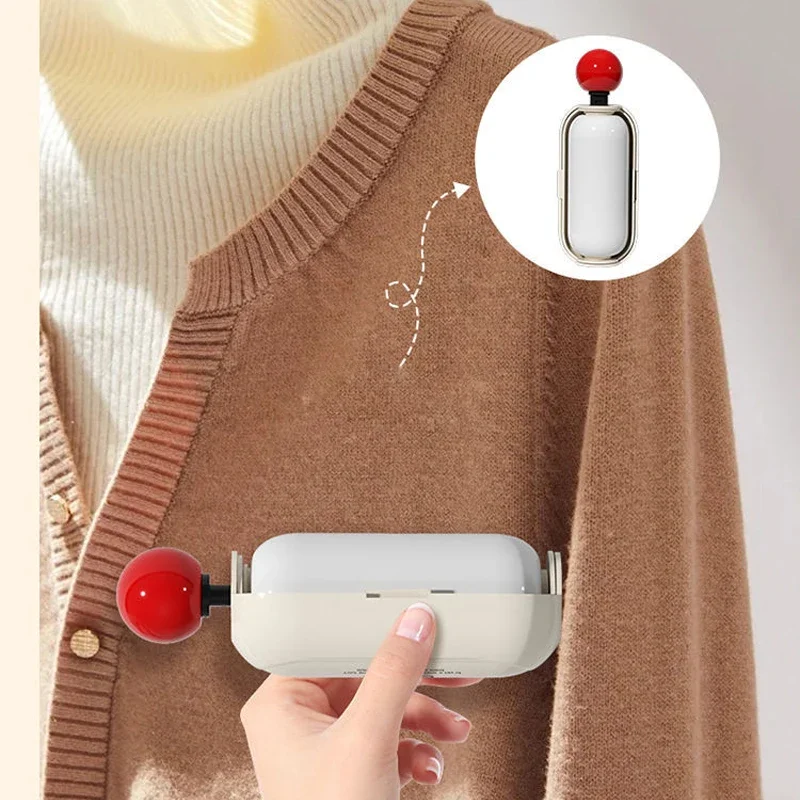 Hand rolling a white capsule roller across a brown knit cardigan at home