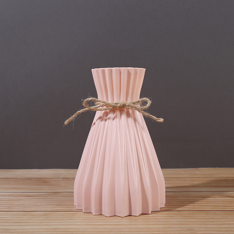 Blush pink pleated vase with a twine bow tied at the waist