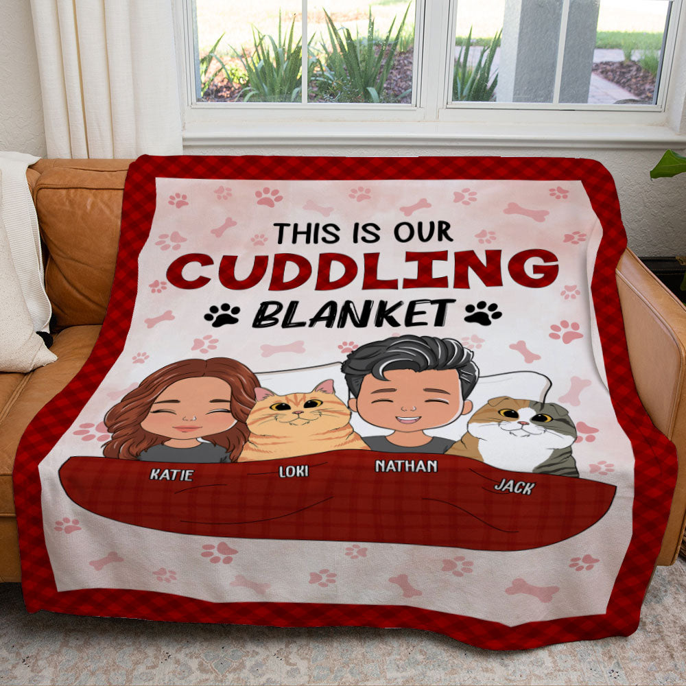 Custom fleece blanket with cuddling couple, two cats, and text 'This is our cuddling blanket'. Perfect gift for pet lovers.